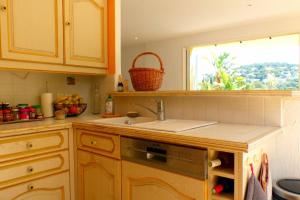 a kitchen with a sink and a window at Spacious and bright house with swimming pool in Bandol +16 photos