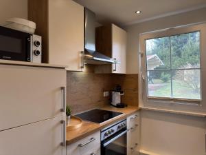 a small kitchen with a sink and a window at Holiday home Max with fireplace in Thale-Friedrichsbrunn in Friedrichsbrunn +29 photos