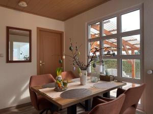 a dining room with a wooden table and chairs at Holiday home Max with fireplace in Thale-Friedrichsbrunn in Friedrichsbrunn