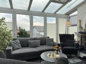 a living room with a couch and a table at Holiday home Max with fireplace in Thale-Friedrichsbrunn in Friedrichsbrunn