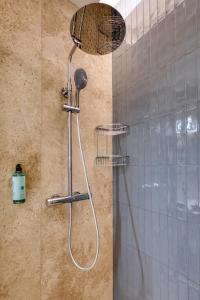 a shower with a shower head in a bathroom at NORFOLK Suites in Sliema +45 photos