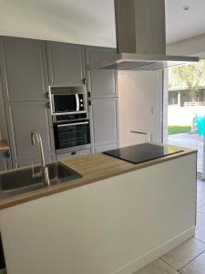 a kitchen with a sink and a stove top oven at La Renardière in Foreste