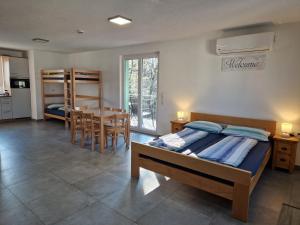 a bedroom with a bed and a table and chairs at Gästehaus Martha in Rust
