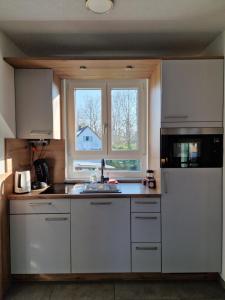 a kitchen with a sink and a refrigerator at Gästehaus Martha in Rust