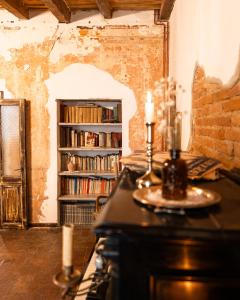 a room with a table and a book shelf with books at Relais il Convento in Palazzago
