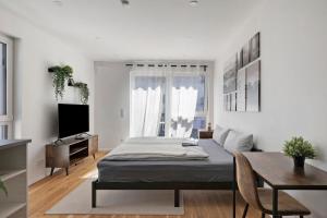 a living room with a bed and a table at Global Bnb - Ay Homes in Augsburg