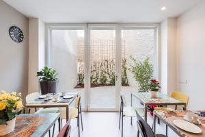 a dining room with tables and chairs and a window at Margherita Home in Reggio Emilia