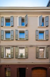 a facade of a building with windows at Margherita Home in Reggio Emilia