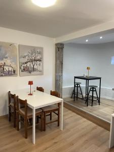 a dining room with a table and chairs and two tables at Locanda al Castello in Travesio