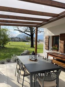 a patio with a table and chairs and a piano at Locanda al Castello in Travesio
