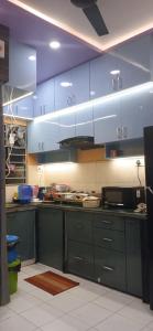 a kitchen with blue cabinets and blue counters at Kaushani Homes in Nangi +6 photos
