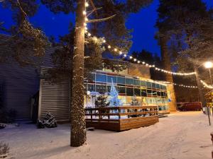 a building with christmas lights in the snow at Värska Veekeskuse hotell in Väike-Rõsna