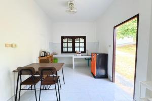 a kitchen with a table and chairs and a refrigerator at Vacation Home Tambon Karon in Karon Beach