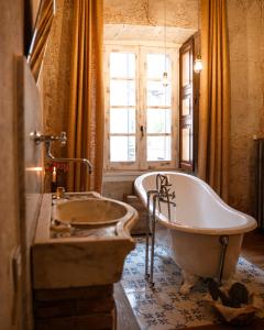 a bathroom with a tub and a sink and a window at Relais il Convento in Palazzago +57 photos