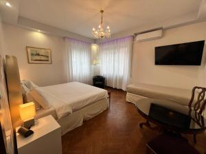 a hotel room with a bed and a flat screen tv at Ca Nart in Venice-Lido +35 photos