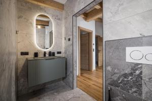 a bathroom with a sink and a mirror at Ahorn Studios in Finsing +44 photos