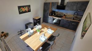 an overhead view of a kitchen with a wooden table and chairs at Apartment Me-Time in Bad Salzungen