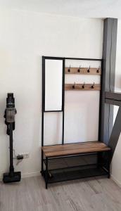a wooden bench in a room with a camera at Apartment Me-Time in Bad Salzungen