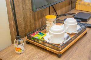 a tray with cups and dishes on a table at House 24 Jahi in Kadobunkuro