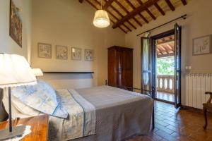 a bedroom with a bed and a sliding glass door at Agriturismo Terralieta in Roseto degli Abruzzi