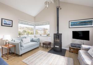 a living room with a couch and a fireplace at Highview, extended 2 bedroom house, with view, near coast path in The Mumbles