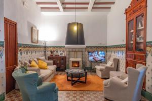 a living room with a couch and a tv at Casa Arizo, Hotel Boutique & Bike Friendly in Oropesa del Mar