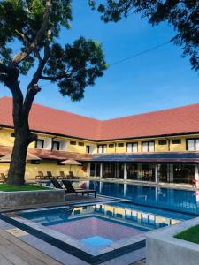 an exterior view of a hotel with a swimming pool at Rajarata Hotel Anuradhapura in Anuradhapura