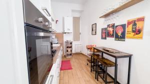 a kitchen with a counter and a table with chairs at Veranda Liberty, luxury apartment in La Spezia