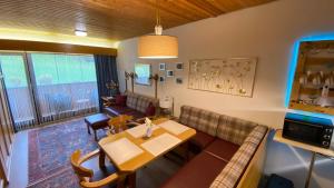 a living room with a couch and a table at Studio SISI in Tauplitz