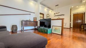 a living room with a couch and a flat screen tv at Veranda Liberty, luxury apartment in La Spezia