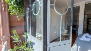a glass door leading into a room with plants at Veranda Liberty, luxury apartment in La Spezia