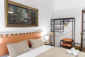 a bedroom with a bed and a painting on the wall at Veranda Liberty, luxury apartment in La Spezia