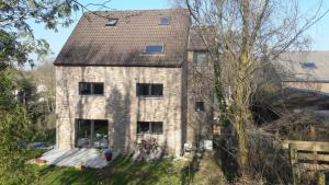 an old brick house with bikes parked in front of it at Coolappart in Mont-Saint-Guibert