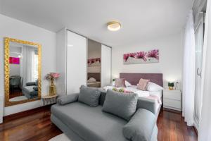 a living room with a bed and a couch at Vila Pivac in Makarska