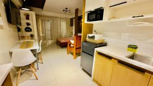 a kitchen with a sink and a counter top at Suntrust88 Tower1-Unit 4Y in Baguio +14 photos