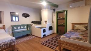 a bedroom with a bed and a room with a stove at Poveste verde in Jurilovca