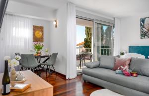 a living room with a couch and a table at Vila Pivac in Makarska