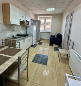 a kitchen with a sink and a table in a room at Апартаменти Пасаж in Skhidnitsa +3 photos