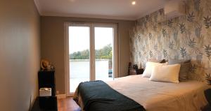 a bedroom with a bed and a large window at Villa perchée à Cahors in Cahors +11 photos