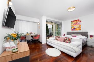 a living room with a white couch and a table at Vila Pivac in Makarska