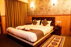 a bedroom with a bed with a table on it at The Lume, Lachung in Lachung +7 photos