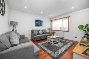 a living room with a couch and a table at Leys Park Executive Apartments in Dunfermline