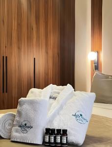 a pile of towels sitting on top of a bed at White Breeze Boutique Hotel in Baku +42 photos
