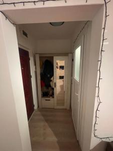 a hallway leading into a room with white walls at Garsoniera in Bacău