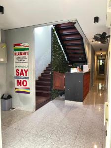 a lobby with a sign that says say no and a staircase at Sentul Inn in Citaringgul 1
