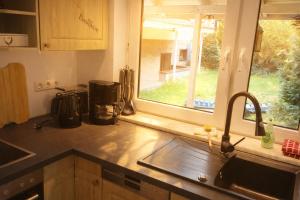 a kitchen counter with a sink and a window at Stiegenstübchen am Weinberg in Dresden