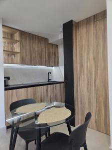 a dining room with two tables and two chairs at Las Campanas de la Catedral Suite Jacuzzi in Burgos