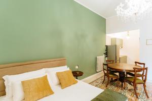 a bedroom with a bed and a table and a dining room at Accuraliving in Piazza Armerina