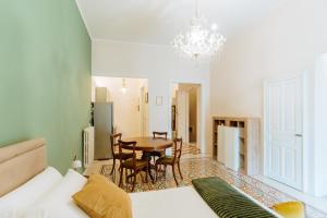 a room with a table and chairs and a dining room at Accuraliving in Piazza Armerina