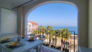 a balcony with a table and a view of the ocean at Trilocale DIRETTAMENTE SUL MARE CON DUE BAGNI cod 510 in Porto Recanati